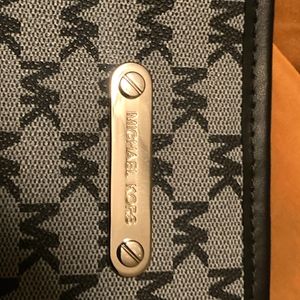 Large, grey Michael Kors bag.